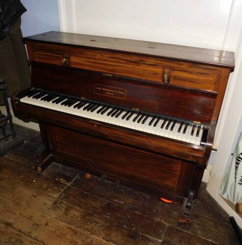 John Broadwood and Sons London. A upright piano in a rosewood case mounted with candle arms (lacking sconces), ivorine keys, etc., 106cm high, 132cm wide.