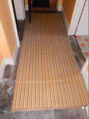 A Dandycord runner and matching matting, in yellow, brown and orange, 364cm x 113cm and 570cm x 91cm.