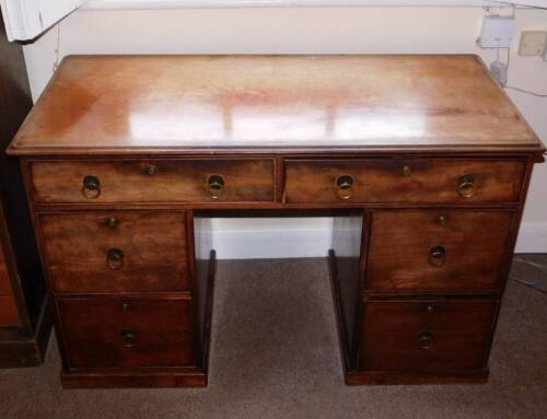 A 19thC mahogany kneehole desk or dressing table, the top with a moulded edge above an arrangement of six drawers, each with ring turned handles and Bramah locks, on a plinth base, 76cm high, 122cm wide, 62cm deep.