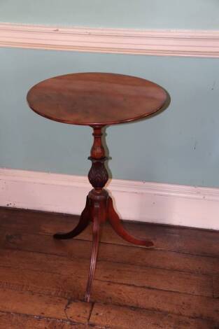 An early 19thC mahogany tripod table, with circular top, acanthus carved pillar on three downswept reeded legs, 76cm high, 50cm diameter.