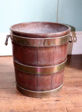 A George III mahogany and brass bound peat bucket, with later zinc liner, brass side handles, 41cm high, the top 36cm diameter.
