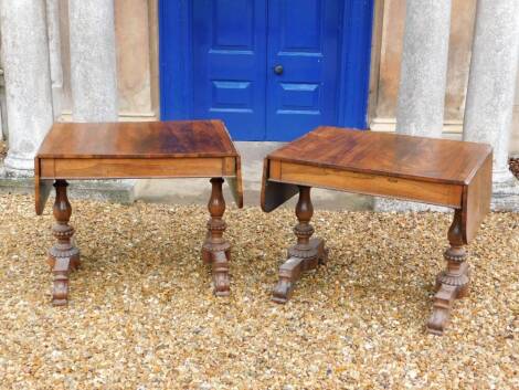 A pair of William IV rosewood sofa tables, each rectangular top with rounded corners above a frieze drawer and a beaded edge, on turned beaded end supports with rectangular platform and scroll carved feet, 73cm high, the top 138cm wide, 71cm deep.