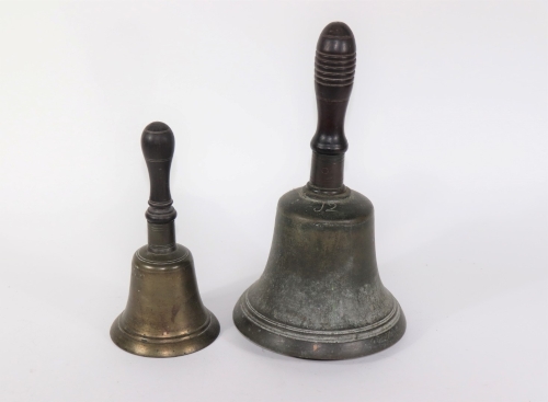 Two Victorian hand bells, with turned wooden handles, 28cm and 20.5cm respectively.