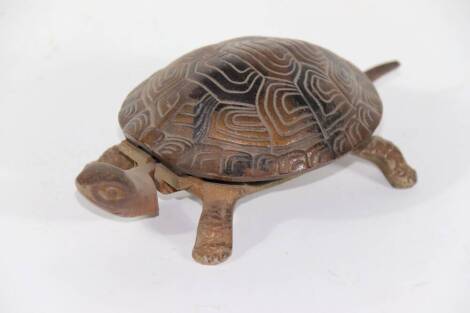 An early 20thC mechanical cast iron tortoise counter top bell, with clockwork movement, stamped GSS, 17cm.