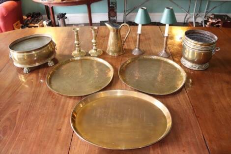 Two Persian brass trays, 48cm diameter, two pairs of brass candlesticks, copper tapered jug and two planters (9)