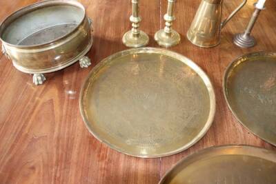 Two Persian brass trays, 48cm diameter, two pairs of brass candlesticks, copper tapered jug and two planters (9) - 2