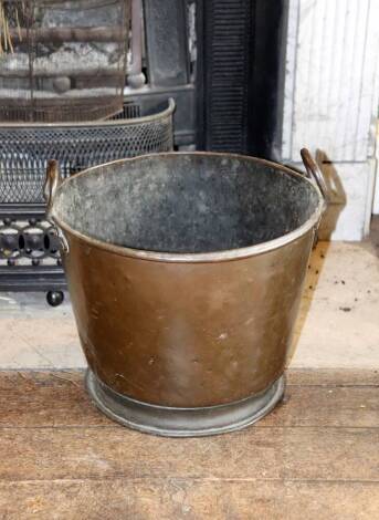 A Victorian copper coal bucket of tapering form, with looped handles, 40cm diameter.