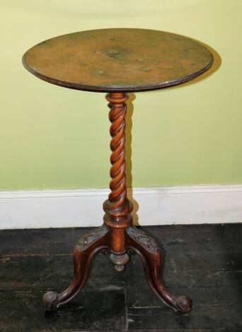 A Victorian walnut occasional table, the circular top on a spirally column and a carved tripod base, 92cm wide. (AF)
