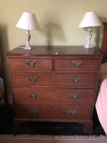 A early 19thC oak chest of drawers, the top with a moulded edge, two short and three long drawers with pierced brass handles on bracket feet, 92cm high, 92cm wide, 46cm deep.