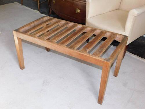 A early 20thC teak luggage stand, of rectangular form on square tapering legs, 91cm wide.