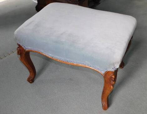 A Victorian walnut stool, with powder blue upholstered padded seat on carved cabriole legs, 64cm wide.