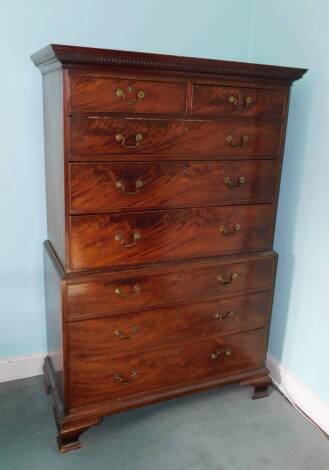 A George III mahogany chest on chest, the top with a dentil cornice and two short and three long drawers, the base with a further three long drawers, each with brass drop handles on ogee bracket feet, 170cm high, 112cm wide, 54cm deep.