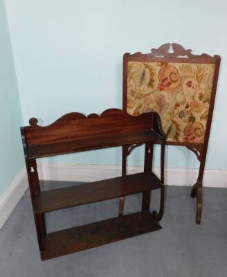 A 19thC mahogany wall shelf, with shaped end supports, 72cm high, 71cm wide (AF) and a 19thC firescreen with embroidered panel. (2)