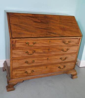 A George III mahogany bureau, the boxwood strung fall enclosing a fitted interior above four graduated drawers on ogee bracket feet, 100cm high, 106cm wide.