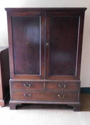 A George III mahogany linen press, with two doors over two short and one long cockbeaded drawer, with brass swan neck handles and bracket feet, 172cm high, 122cm wide, 62cm deep.