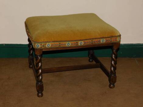 A 1930's barley twist oak stool, with upholstered top.