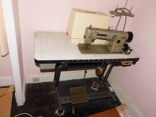 A Brother treadle tabled electric industrial sewing machine.