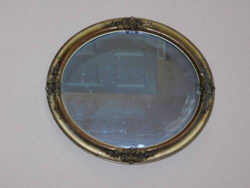 A Victorian gilt wood and gesso wall mirror, with oval plate, 45cm x 40cm. (AF)