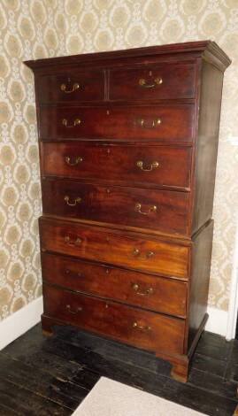 A George III mahogany chest on chest or tallboy, the chest with a moulded cornice above two short and three long drawers, the base with four long drawers, each with brass drop handles and bracket feet, 187cm high, 112cm wide, 57cm deep.