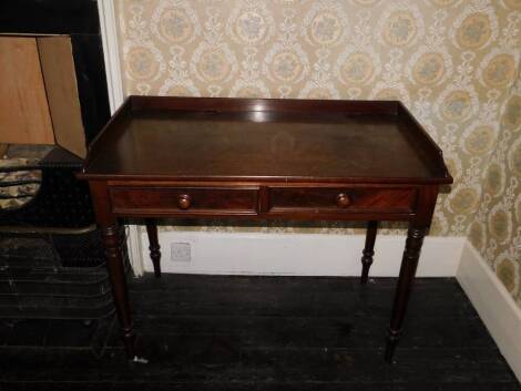 A early Victorian mahogany washstand, with a raised gallery above two frieze drawers, each with turned wood handles on turned tapering legs, 78cm high, 103cm wide, 54cm deep.