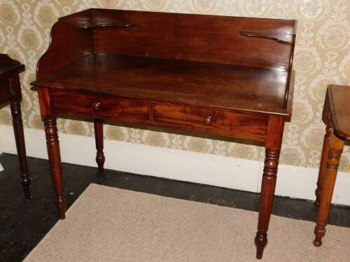 A Victorian mahogany washstand in the manner of Holland & Son, the raised gallery with corner brackets raised above two false frieze drawers on turned tapering legs, 101cm high, 112cm wide, 58cm deep.