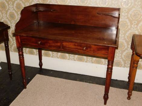 A Victorian mahogany washstand in the manner of Holland & Son, the raised gallery with corner brackets raised above two false frieze drawers on turned tapering legs, 101cm high, 112cm wide, 58cm deep.