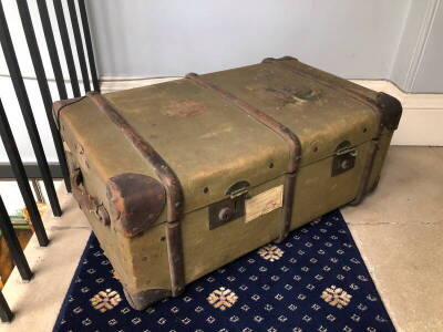 A metal and wooden bound green canvas cabin trunk, 32cm high, 77cm wide, 47cm deep.