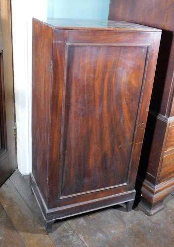 An early 19thC mahogany folio cabinet, the top with a moulded edge and a single panelled door enclosing shelves on square tapering legs, (AF), 105.5cm high, 51cm wide, 34.5cm deep.