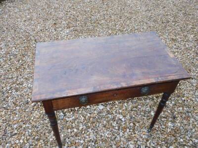 A late George III mahogany reading or folio table, the rectangular top with a crossbanded border and brass holes for a support, with ratchet support beneath, above a frieze drawer with gilt metal cast, ring handles, on ring turned tapering legs and brass - 3