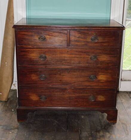 An early 19thC chest of drawers, top with a moulded edge above two short and three long drawers with oval brass handles on bracket feet, 106cm high, 110cm wide, 57cm deep.