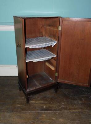 An early 19thC mahogany folio cabinet, the top with a moulded edge above a single panelled door enclosing shelves flanked by brass side handles on square tapering legs, 108cm high, 47cm wide, 34cm deep. (AF) - 2