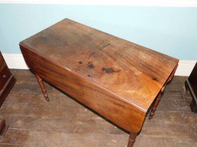 An early Victorian mahogany Pembroke table, the top with rounded corners above a frieze drawer opposing a false drawer with single turned handle, on ring turned tapering legs with brass castors, 72cm high, 108cm wide. - 2