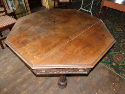 A Victorian Gothic oak library table, the octagonal planked top with a moulded edge above an arrangement of four drawers and four false drawers, each carved with scrolls, etc., on four octagonal supports, joined by an X shaped stretcher, with loped pater - 2