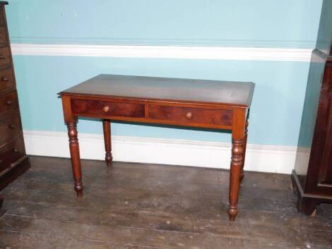 An early Victorian mahogany side table, the top with a moulded edge above two frieze drawers each with turned wood handles, on turned tapering legs, 71cm high, 109cm wide, 54cm deep.