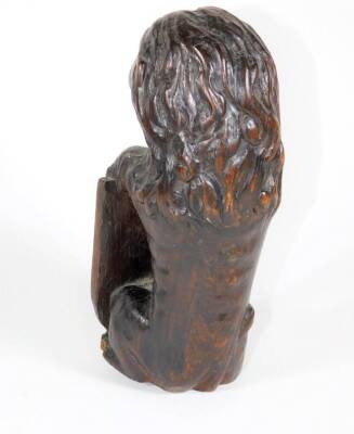 A 19thC carved oak lion surmount, in a seated pose holding an heraldic shield, 25cm high. - 2