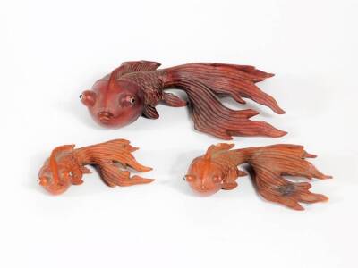 Three Oriental carved wooden figures of Shubunkin, 15cm long down.