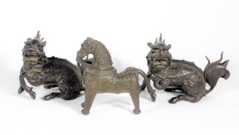 A pair of 19thC Chinese bronze figures of kylins, 15cm long and a cast bronze horse 13cm high. (AF-loss to rear hoof, 3)