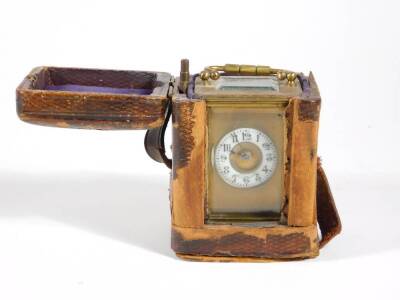 A late Victorian brass cased carriage clock, the enamelled chapter ring with Arabic numerals, visible escapement, 10cm high (handle up), and the red leather travelling case, with key. - 2