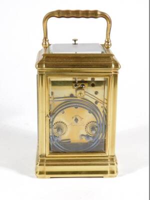 An early 20thC brass cased carriage clock, with moulded case and fluted corners, with a white enamelled dial with Roman numerals and Arabic minutes, with visible escapement to the repeating and striking eight day movement, in a fitted red leather case for - 5