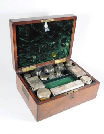 A Victorian burr walnut ladies travelling toilet case, with inlaid brass cartouche to the hinged lid and brass bound edges, with inset handles, the interior fitted with four bottles, jars and accoutrements, with green plush linings and moire silk, within 