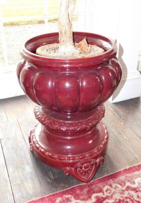 A large Vallauris sang de boeuf glazed pottery jardiniere on stand, impressed C.M. (for Clement Massier) over VALLAURIS over A.M., 71cm high, 47cm diameter. Note: This is not Burmantofts as known historically and stated in an early catalogue version. - 2