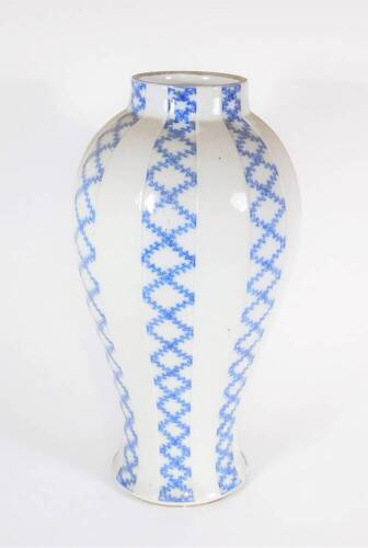 A 19thC blue and white moulded baluster vase, with painted trail decoration, 40cm high.