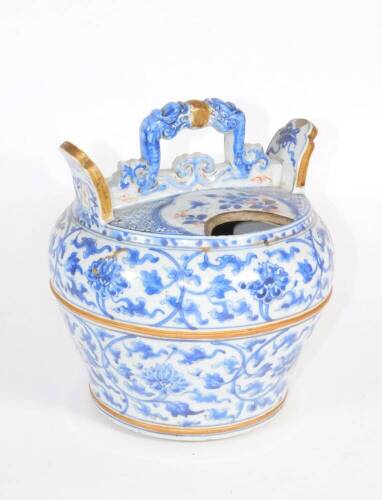 A 18thC Chinese wine pot, of inverted baluster form having loop handle and gilt lugs, diaper deist to the top with reserves and gilding on the blue and white floral body, partially glazed foot with double ring, 22cm diameter. (AF - bruise to lug and damag