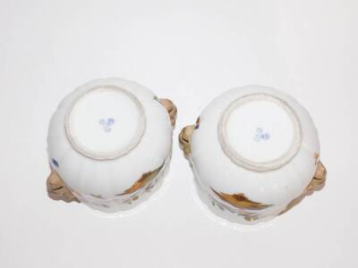 A pair of Dresden porcelain cache pots, hand painted with birds and having lion mask handles, AR scroll mark in underglaze blue, 12cm high. (AF -one with a loss to the rim) - 5