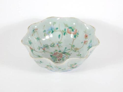 A 19thC celadon glazed Chinese porcelain bowl enamelled with peony branches, with wavy edge and six character Tongzhi seal mark to base and probably of the period (1862 - 1874), 17cm diameter.