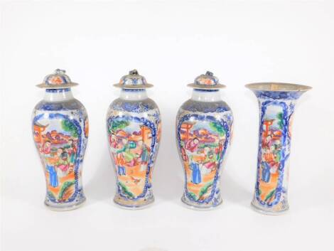 A group of four 18th/19thC Chinese famille rose and blue and white porcelain vases, comprising three baluster vases with covers and a flared beaker vase with similar court scenes and reservoirs in polychrome colours, 18cm high. (AF - various losses and re