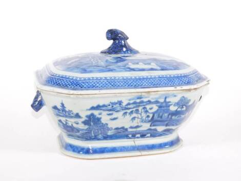 An 18thC Chinese blue and white porcelain tureen and cover, decorated with pagodas, bridge and boats, 32cm over handle. (AF - hairline crack extensively through the base)