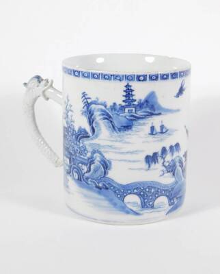 An early 19thC Chinese blue and white porcelain pallet mug, handpainted with landscape, boats, figures, and pagodas, 14cm high. (AF - loss to foot of handle, two chips to the rim) - 2