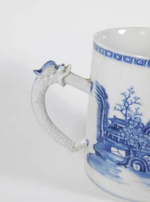 An early 19thC Chinese blue and white porcelain pallet mug, handpainted with landscape, boats, figures, and pagodas, 14cm high. (AF - loss to foot of handle, two chips to the rim) - 4