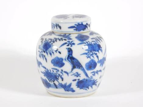 A late 19thC Chinese blue and white porcelain ginger jar and cover, handpainted with birds and flora, four character Kangxi mark to base, 10cm high.